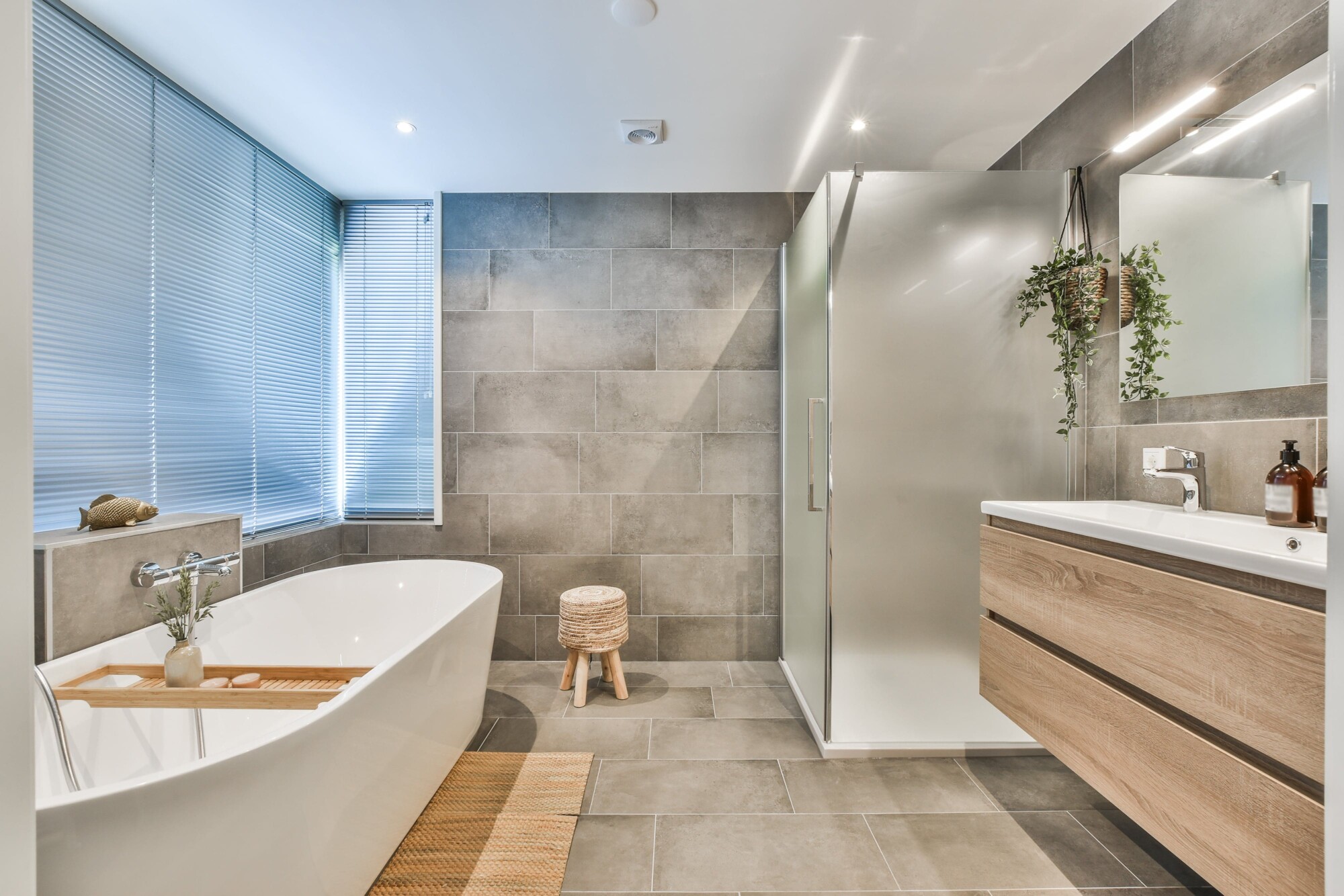 large renovated bathroom with matching grey wall and floor tiles
