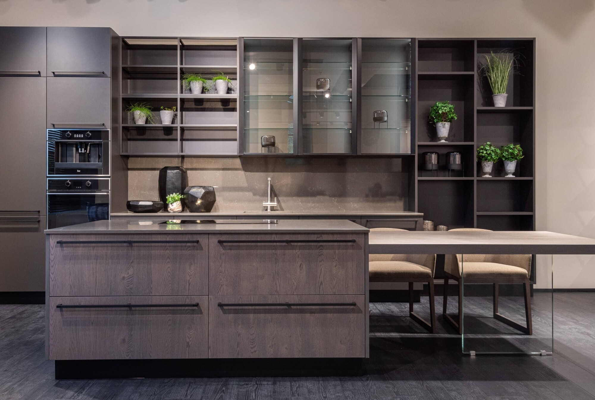 A Redesigned new build kitchen featuring dark brown kitchen with large shelves, a kitchen island and dining table